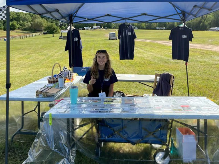 young woman under a blue tent in the park